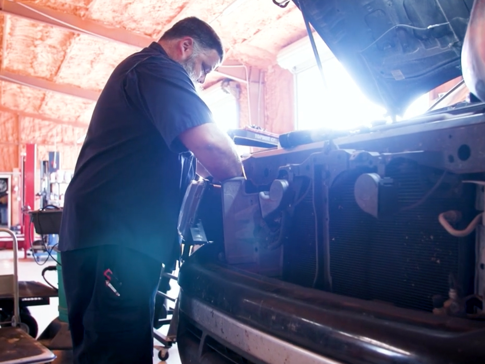 Top auto shop near me — ASE Certified mechanic working under the hood