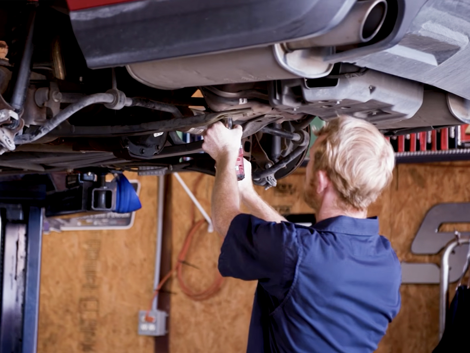 Best auto service near me — ASE Certified mechanic under a vehicle