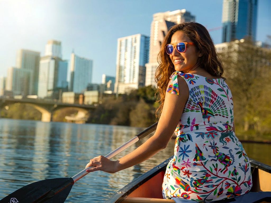 Austin, Texas downtown skyline at golden hour reflected in Lady Bird Lake