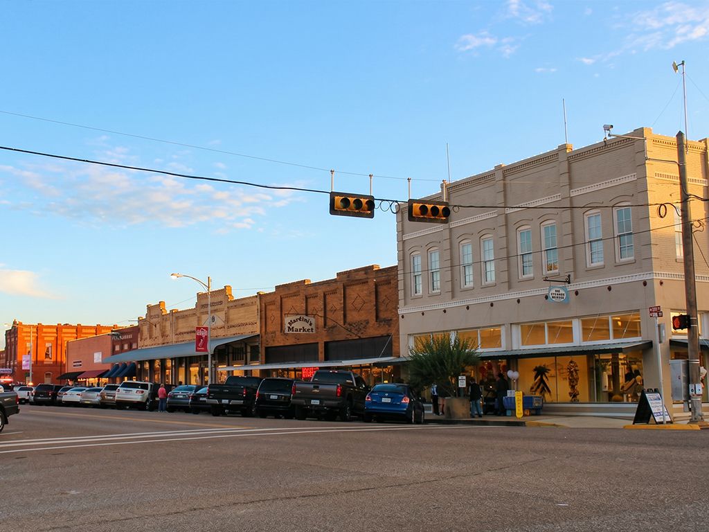 Restored late-1800s red brick storefronts along the main street of downtown Elgin, Texas