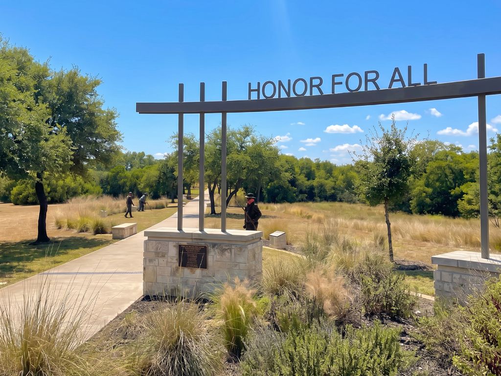 Stone memorial wall and American flag at Veterans Memorial Park in Elgin, Texas