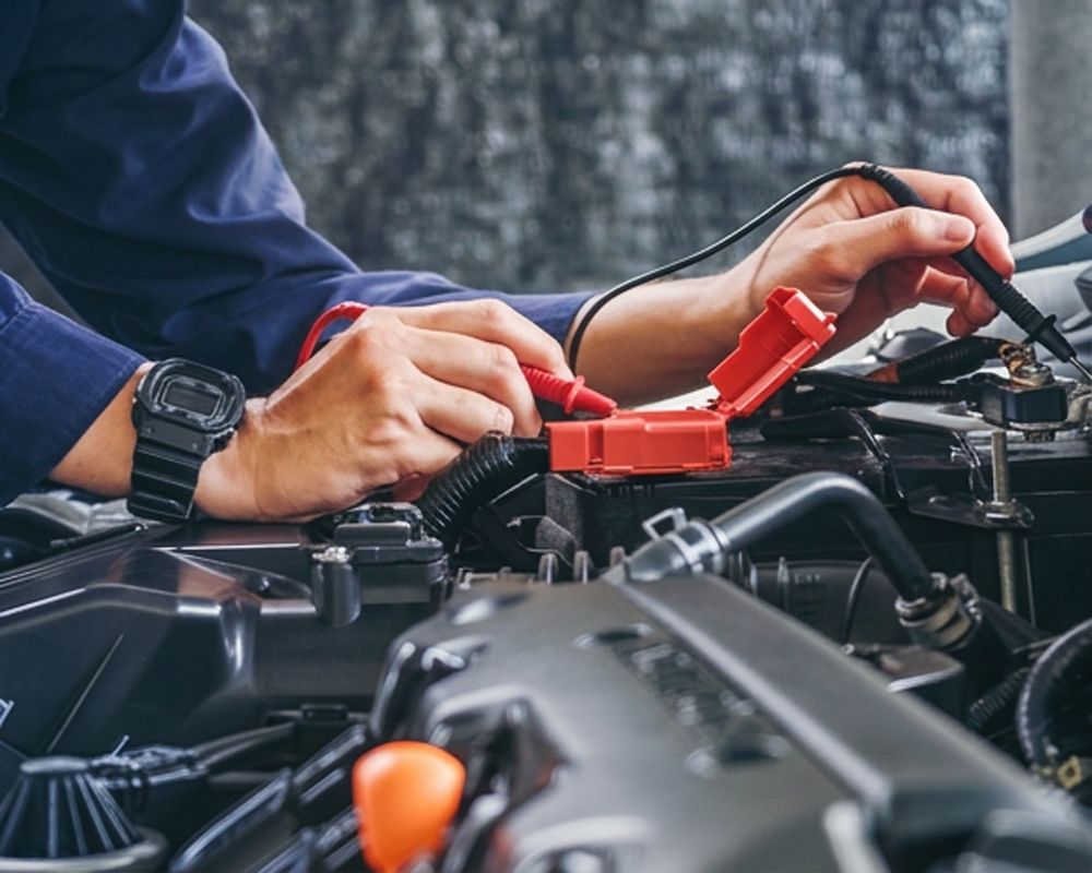 ASE Certified mechanic performing Battery Inspections & Replacements